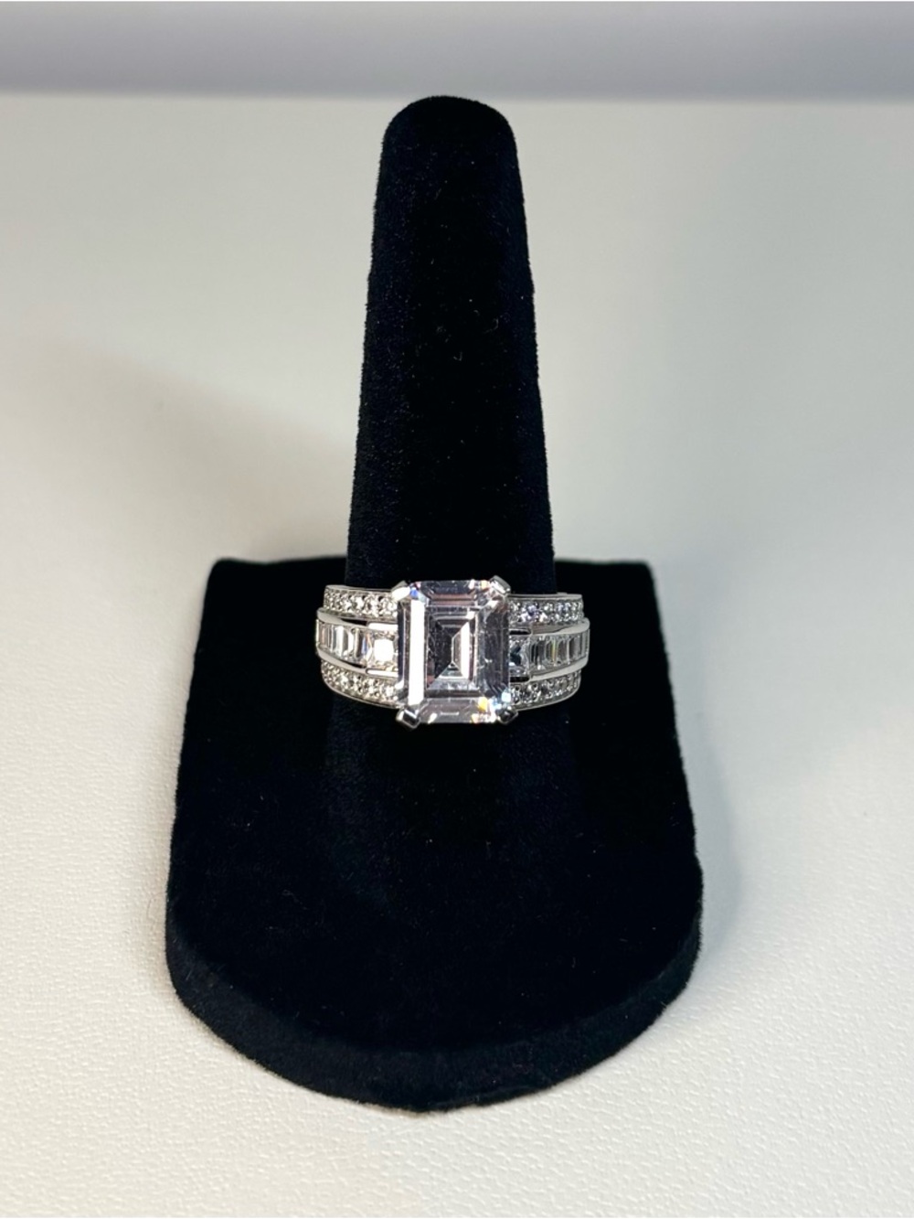 Sterling silver ring with a ~5 carat, sparkly emerald-cut center stone